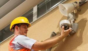 SECOM field engineer working on a security camera