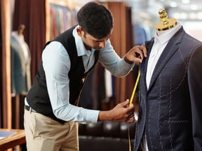 A man measuring a tailor made suit